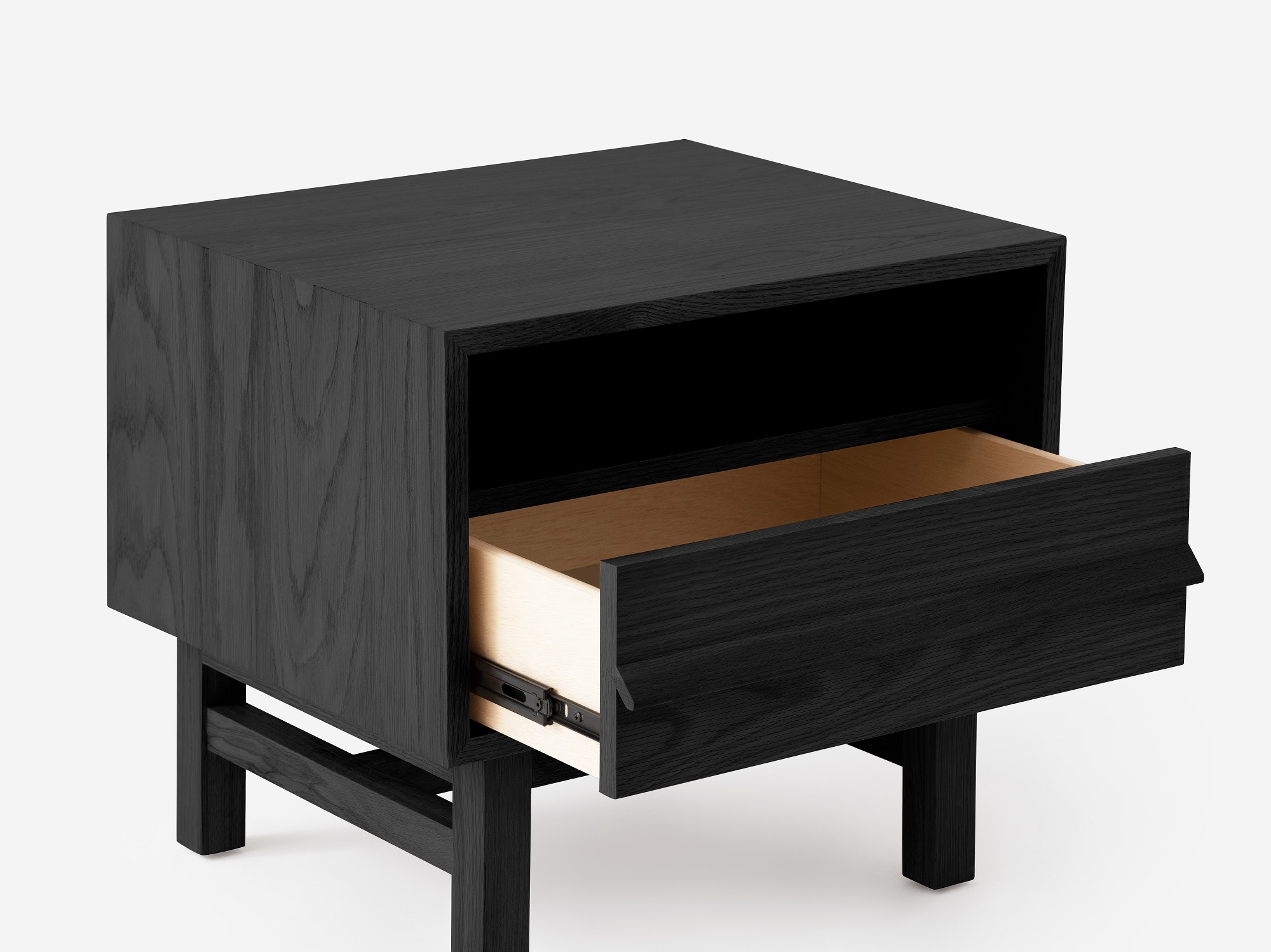 Angled view of the Marcel open shelf modern nightstand in black oak with drawer open